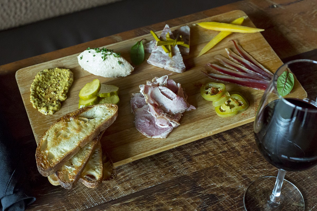 DeVine’s charcuterie plate includes a selection of house-cured meats and house-pickled vegetables