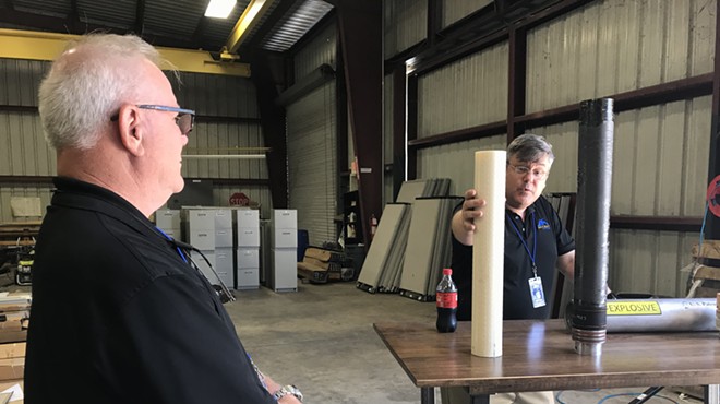 VP of Propulsion Robert Fabian (right) and Chief Technologist Ron Jones (left) present two cylinders of 3D-printed rocket fuel during a media tour on Monday, May 7 at Rocket Crafters' Cocoa Beach manufacturing facility.