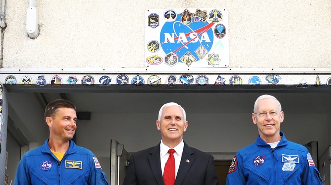 Mike Pence leaves a tour of NASA's Operations and Checkout Building in Cape Canaveral with NASA astronauts Reid Wiseman (left) and Pat Forrester on July 6 2017.
