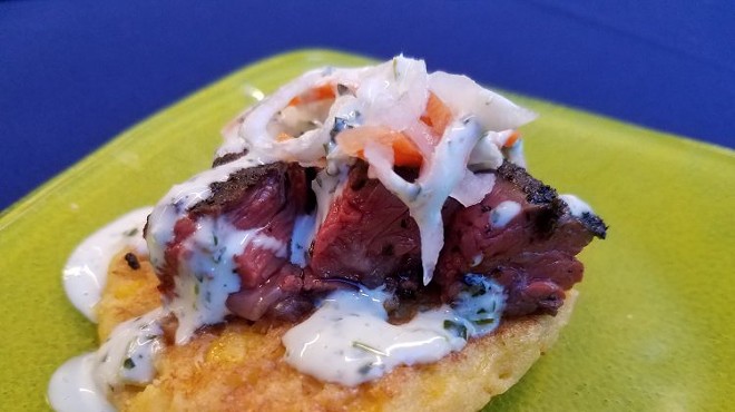 Charred chimichurri skirt steak on a smoked corn cake with pickled vegetable slaw and cilantro aioli. (Flavors From Fire)