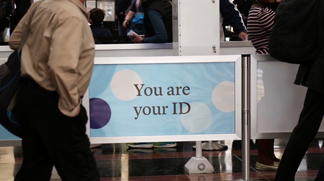 A railing with a facial recognition company's branding reads "You are your ID" at the Ronald Regan International Airport in Washington D.C.