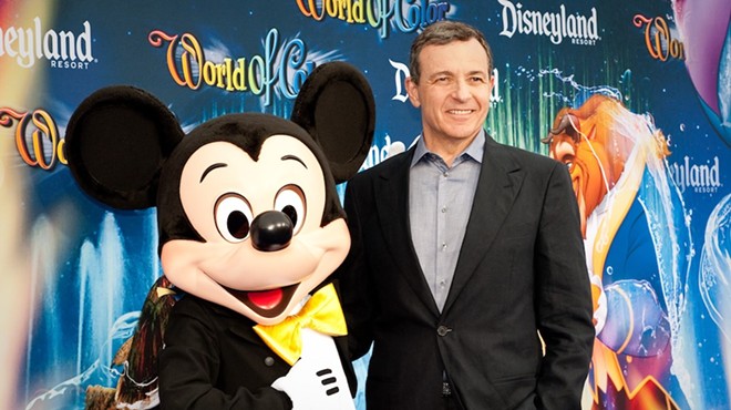 Disney CEO Bob Iger with a Disney employee in costume