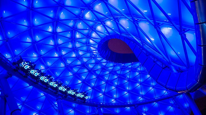 A Tron coaster car in the outside portion of the ride under the roof strutcture at Shanghai Disneyland