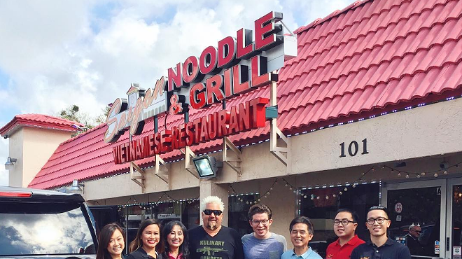 The Nguyen family, owners of Saigon Noodle & Grill, poses for a pic with Fieri after taping the show.
