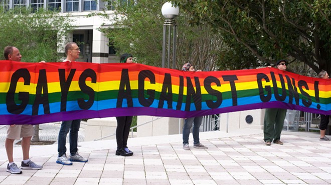 The group Gays Against Guns holds a rainbow banner outside the Orange County courthouse in support of the assault weapons ban.