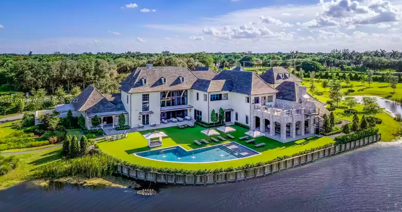 1-800-411-PAIN founder, his identical twin list dueling Florida mansions for $54 million