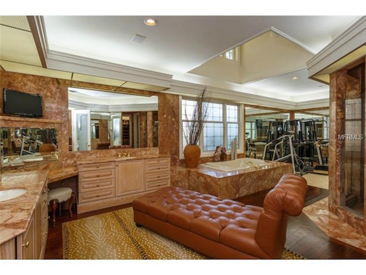 One of the bathrooms appears to have its own workout room, as well as a fainting couch.