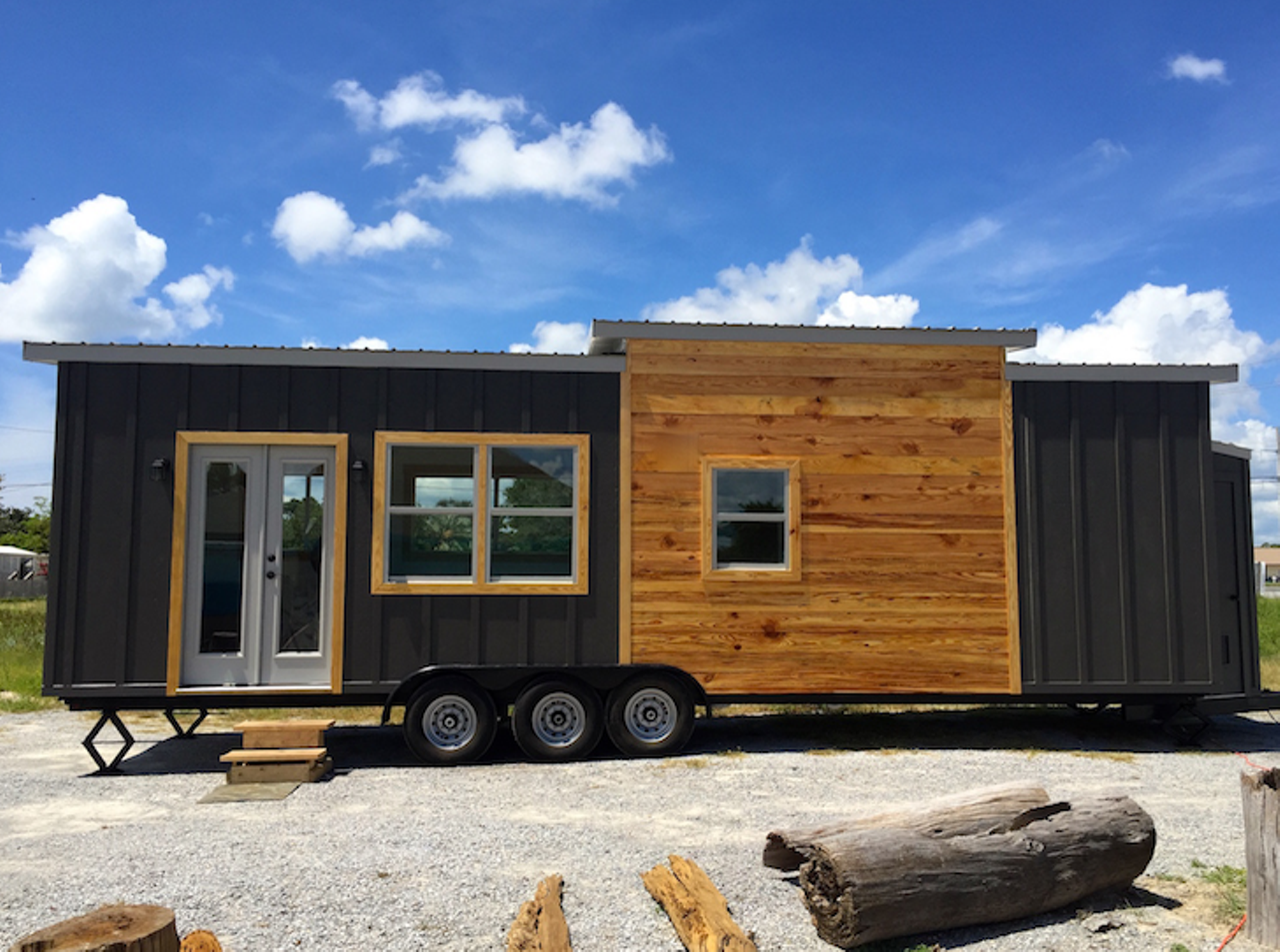 32' Irving Model
Location: Panama City
Price: $67,988
Size: 350 sq. ft.
This mini home is sleek and modern with a black interior and exterior design. It makes other mini homes look weak compared to it with its fierce design featuring two bedrooms that slays all around.