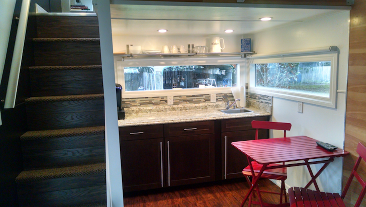 Modern Tiny House on Wheels
Location: Orlando 
Price: $65,000
Size: 370 sq. ft.
It features a granite kitchen area where you can whip up quick meals to eat in the beautiful red contrast dining room tables.
