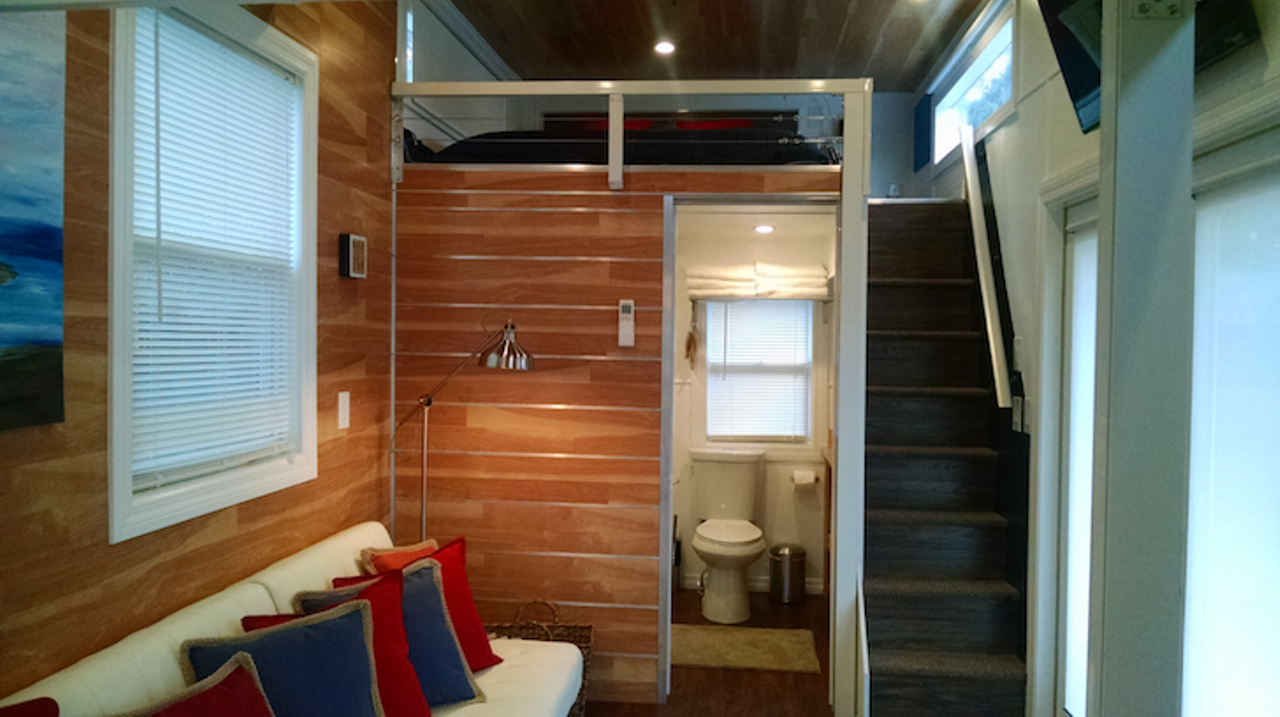 Modern Tiny House on Wheels
Location: Orlando 
Price: $65,000
Size: 370 sq. ft.
There's great leg room to chill in this comfy couch overlooking the patio area.

