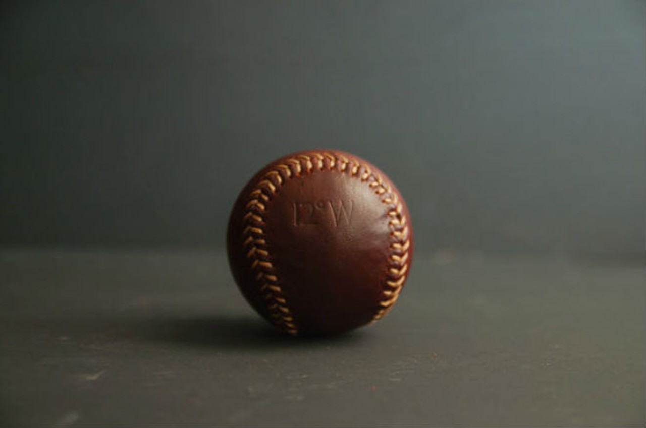 12 Degrees West
Specializes in: handcrafted leather goods 
Custom leather baseball; $40
Photo via 12 Degrees West