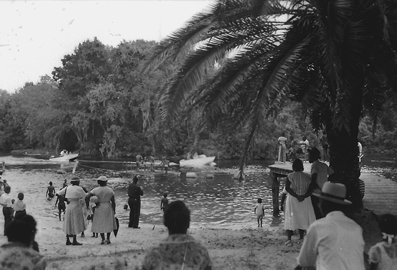A group of visitors look out toward the float in the swimming area of Paradise Park. The boat dock is to the right. Photo by Bruce Mozert. By permission of Bruce Mozert. Reprinted with permission of the University Press of Florida.