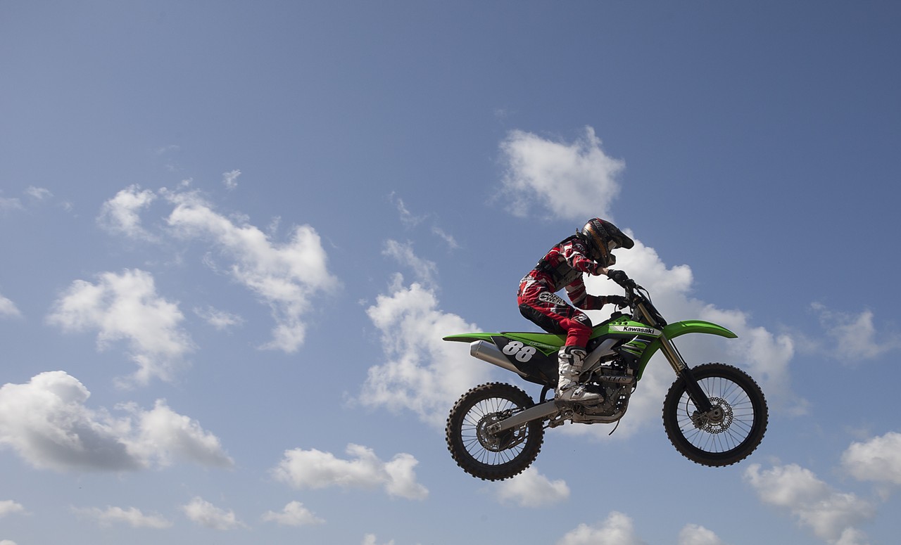 Motocrosser flies through the air at the track adjacent to Orlando Speed World. July 29, 2012.