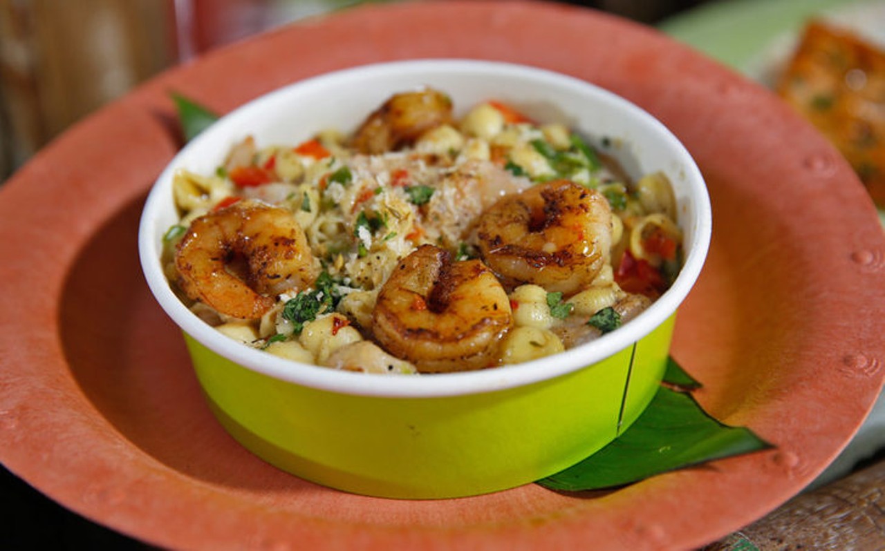 Jerk Shrimp Mac & Cheese 
Whakawaiwai Eats, Volcano Bay
A large bowl of this cheesy and buttery delight is sure to keep you full and maybe you&#146;ll even need to share a little bit. The tender Jamaican jerk-spiced shrimp is pan-seared in butter and tossed with pasta shells in a velvety white cheddar cheese sauce that is to die for. Although most restaurants offer a better version of this dish, Volcano Bay has whipped out its own version and made the unexpected at a theme park. This meal does come with a large price tag though, at $15.99 for just the mac and cheese and $19.49 as a combo.
Photo via Jerk Shrimp Mac & Cheese/Discovery Universal Blog