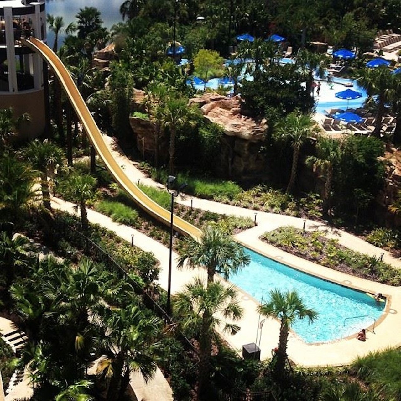 Orlando World Center Marriott Resort
8701 World Center Drive, 407-239-4200
The World Center Marriott packs on the thrills at its pools, with two winding, 200-foot water slides and a 90-foot super fast speed slide. But if the thought of hurtling full-speed into a body of water makes a little queasy, there&#146;s plenty of opportunities for relaxing, stationary fun at the hotel&#146;s oasis pool and hot tub grotto nestled under a rocky waterfall. The pools open at 8 a.m. and close at 11 p.m., but don&#146;t wait until the last minute to take that final water slide ride, as they usually close an hour earlier. Only guests staying at the resort and their visitors are allowed to use the pools and slides. 
Photo via Orlando World Center Marriott Resort/Facebook
