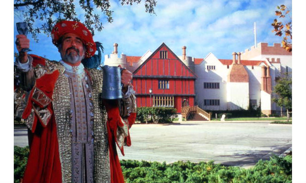 Man posing at the King Henry's Feast attraction, where guests could celebrate King Henry VIII's birthday twice-nightly in his castle on I-Drive, with chicken, ribs and unlimited beer and wine served by wenches.