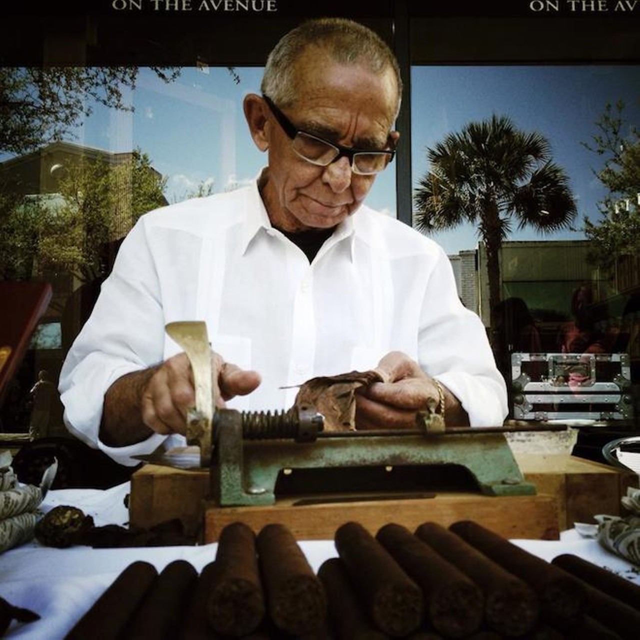 A man rolls cigars on Park Avenue in Winter Park