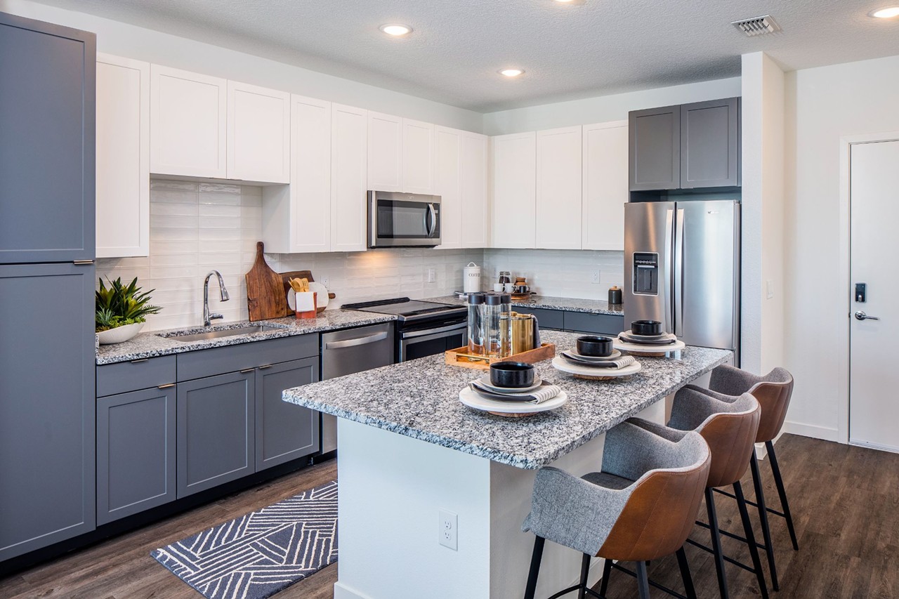 Contemporary kitchens with granite countertops, stainless steel appliances, ceramic tile backsplash, and built-in pantry storage