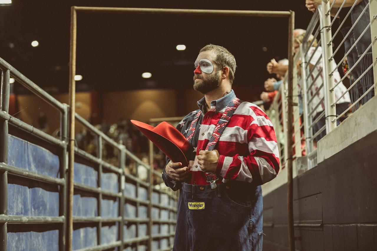 Clint Parrish, rodeo clown and barrelman, waits for the national anthem to end to start his pre-show act.