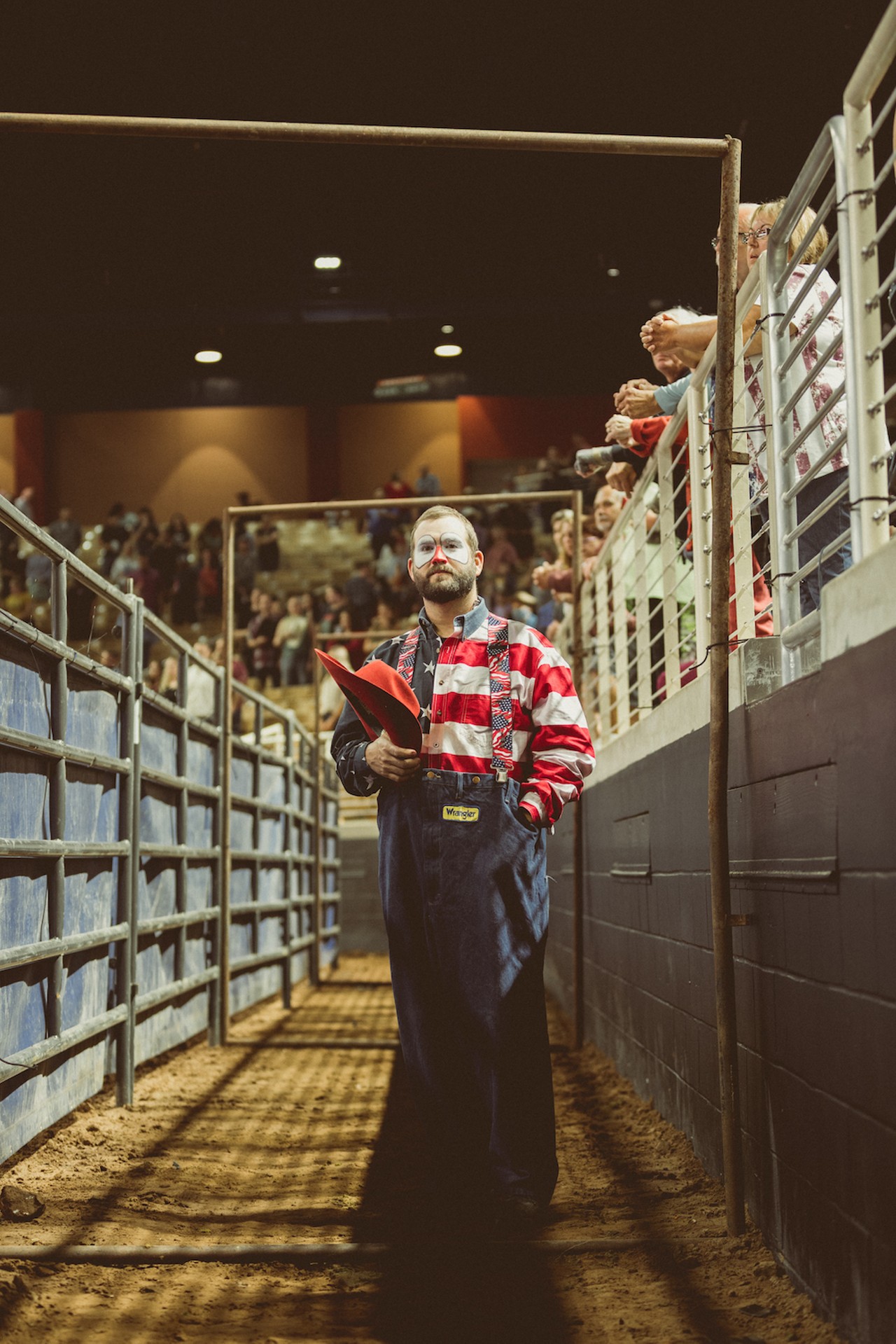 Clint Parrish, rodeo clown and barrelman, waits for the national anthem to end to start his pre-show act.