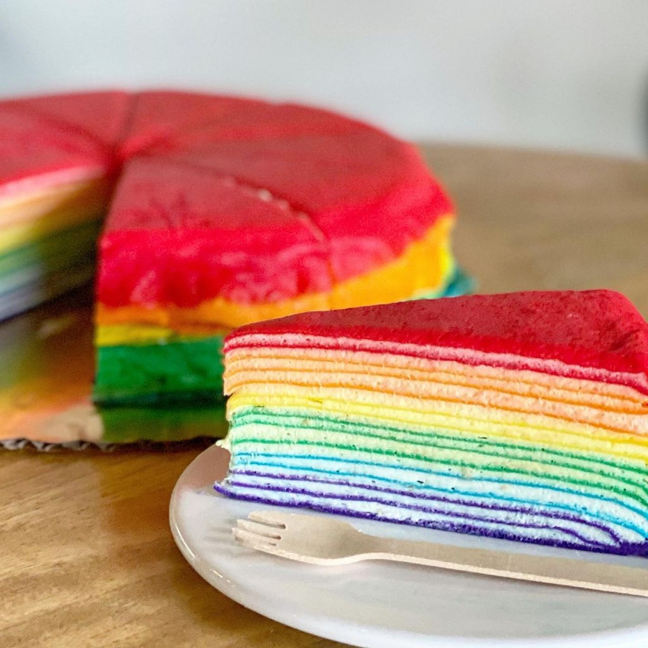Light On The Sugar 
4270 Aloma Ave Suite #112 Winter Park FL 32792, (407) 916-0215
While they are known for their delicious teas and pastries, this month they have exploded social media with their new Pride options, including the Rainbow Vanilla Crepe cake. 
Photo via Light On the Sugar/Facebook