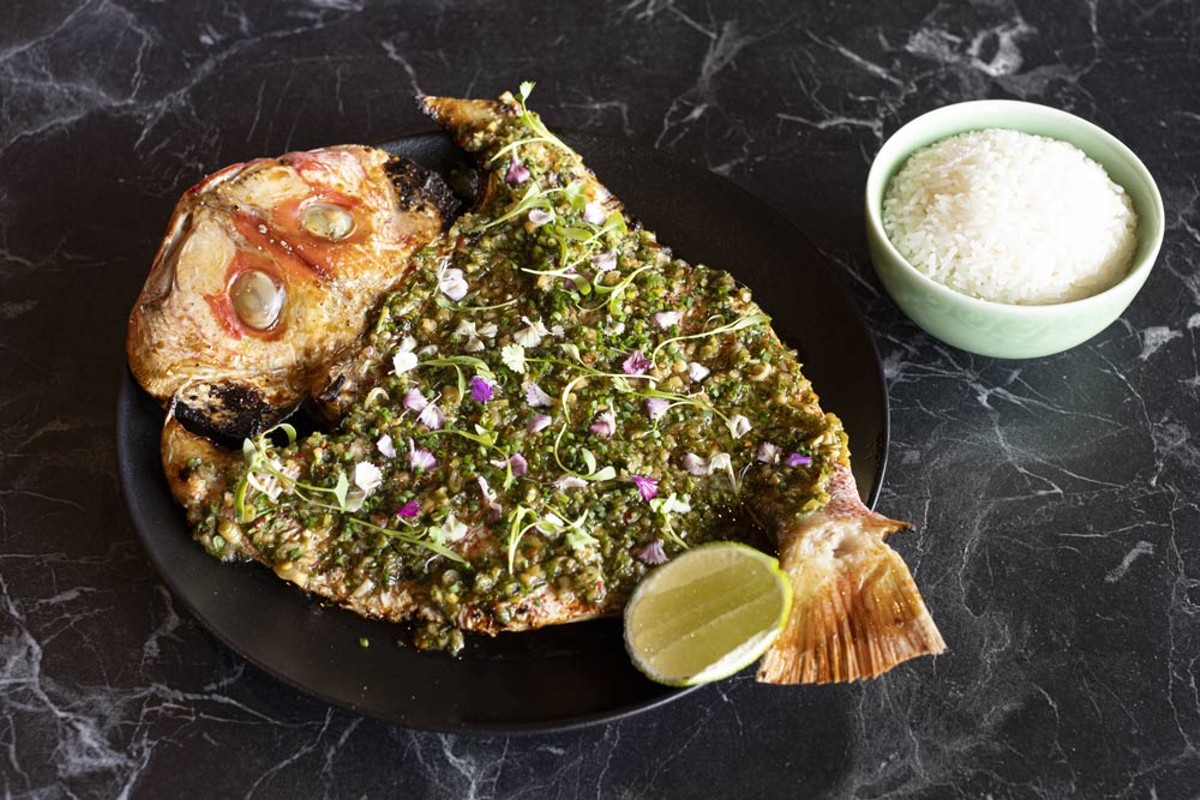 Butterflied, fire-roasted whole fish is brightened up with scallion chimichurri