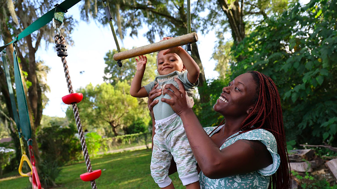 Jasmine Brown plays with her youngest son, Elijah, in the backyard of her home in Marion County, Fla., Thursday, Oct. 5, 2023.