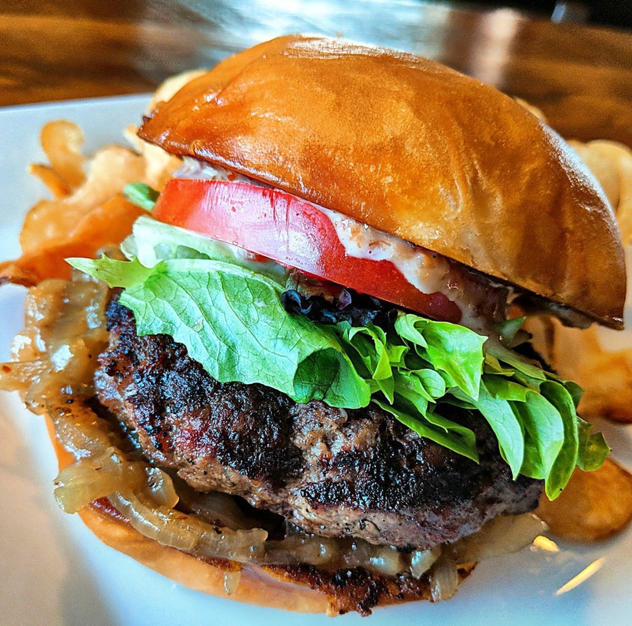 Crooked Spoon: Blue Point Burger - Angus beef patty, Blue Point Toasted Lager braised onions, bacon gastrique aioli, mixed greens, tomato, Aleppo & Urfa pepper crusted brioche bun. $3 more gets you a Blue Point Toasted Lager Draft.