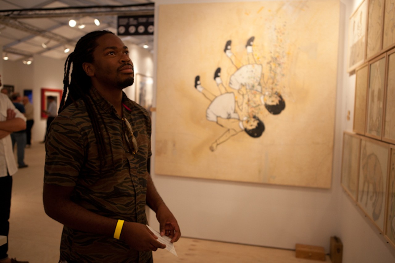 Brandon Christopher, a graphic designer and artist from Orlando, takes in the works at Scope art fair on South Beach.
Location: Scope Art Fair on the sand of South Beach, Miami