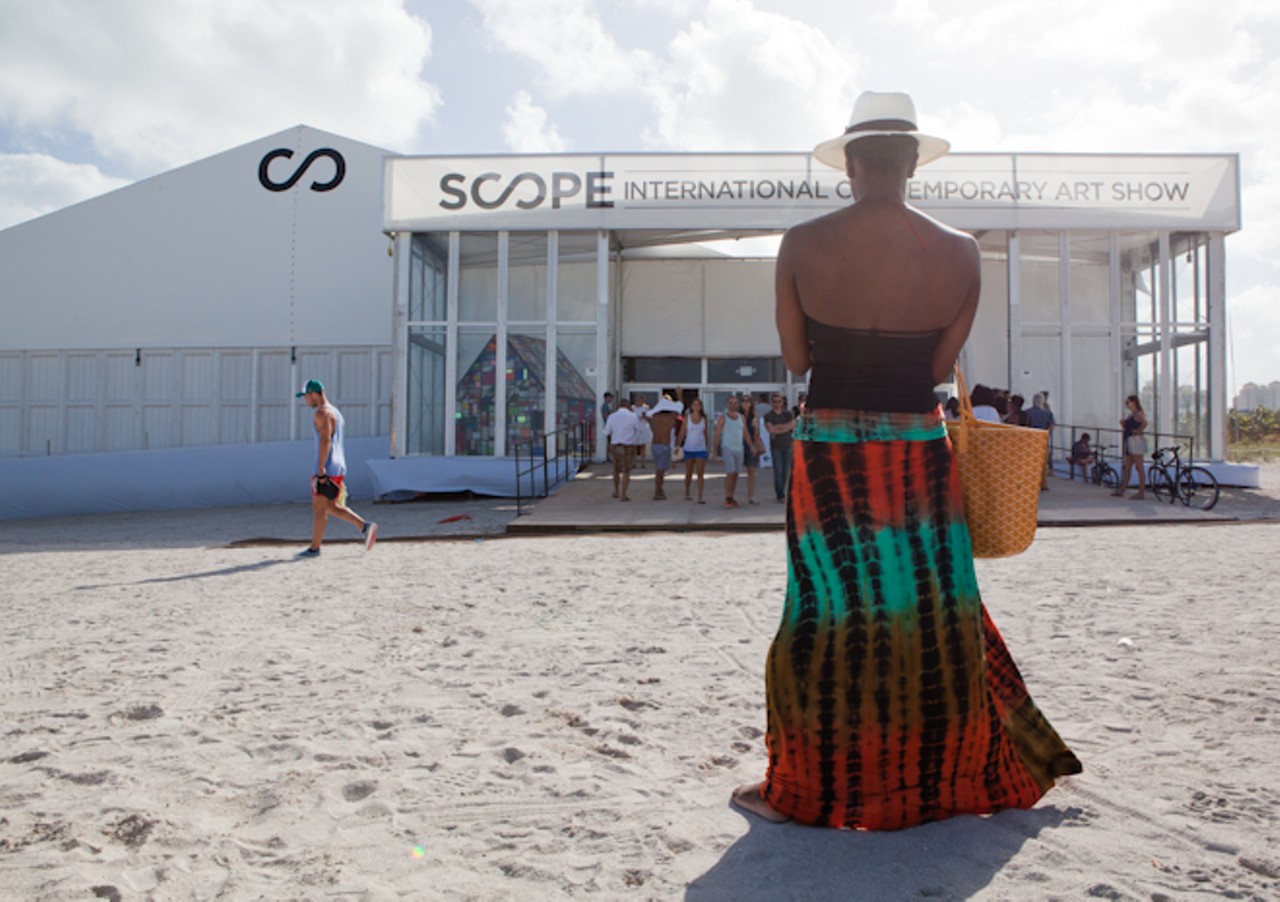 Scope Art Fair was set up directly on south beach this year.
Woman displaying her Miami fashion as she heads in to the fair.
Location: Scope Art Fair on the sand of South Beach, Miami