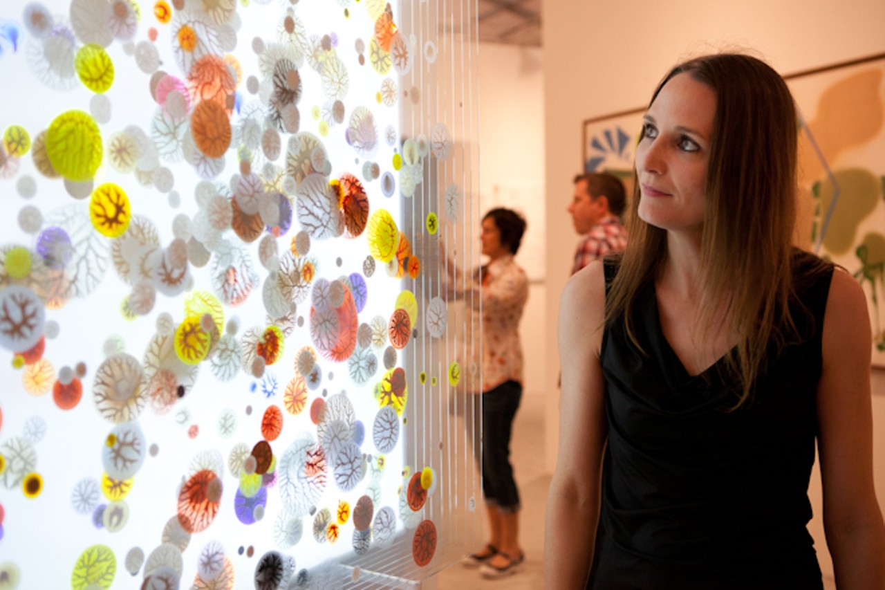 Coralie Claeysen-Gleyzon and Dennis Liddy of Jai Gallery in Orlando check out the trends at the art fairs this year. Coralie points out the multitude of pieces incorporating layers, such as this backlit layered glass piece by Peter Byum pictured here.Context Art Fair