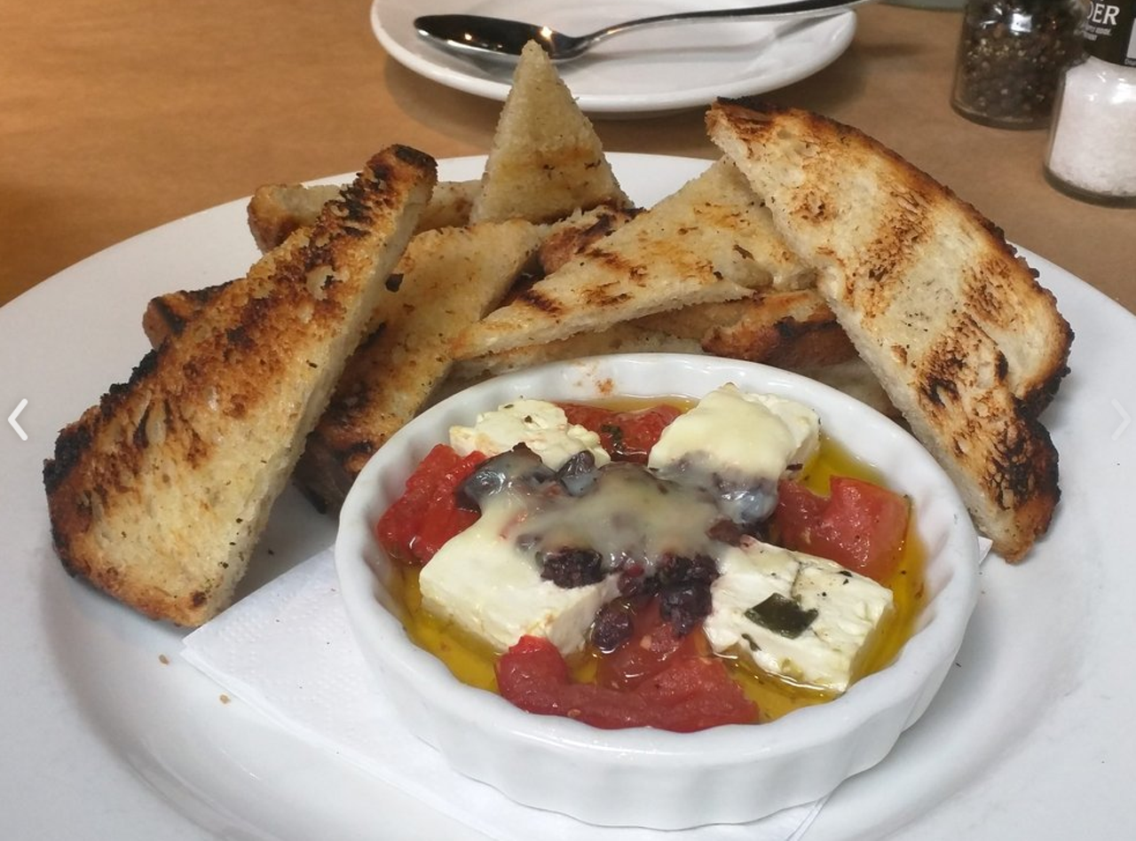  Baked feta at Artisan&#146;s Table
22 E. Pine St., 407-730-7499 
Mediterranean flavors are at the forefront when this warm cheese app comes to the table. Smear the feta on warm bread and top with olive oil, kalamata olives and confit tomatoes.
Photo via Artisan's Table/Yelp