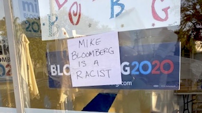 Mike Bloomberg a 'racist' and 'sexual predator,' according to signs stuck to his Florida campaign office windows