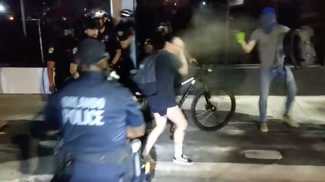 Orlando Police officers use tear gas on a protester