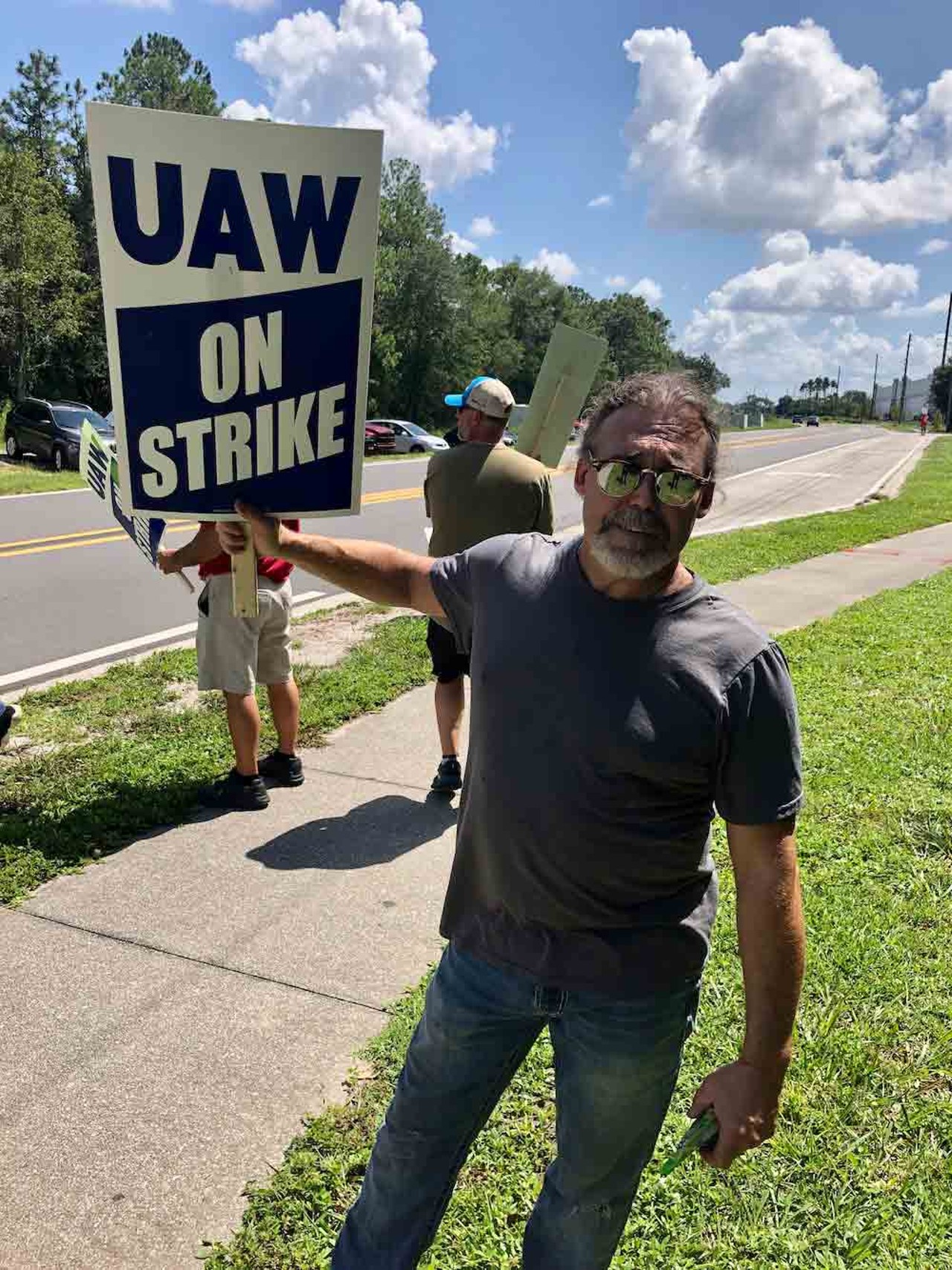 Christopher Marshall, a UAW member and former contractor with the IBEW, strikes alongside his fellow union members in Orlando on Sept. 22, 2023.
