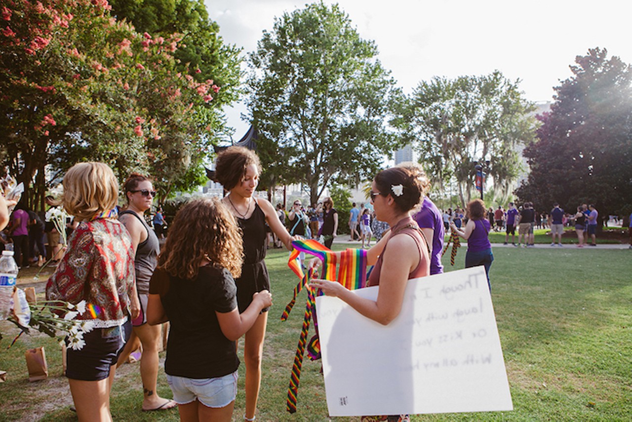 Handing out rainbow ribbons on a sunny Sunday afternoon at the June 19 Lake Eola vigil.
Photo by Hannah Glogower