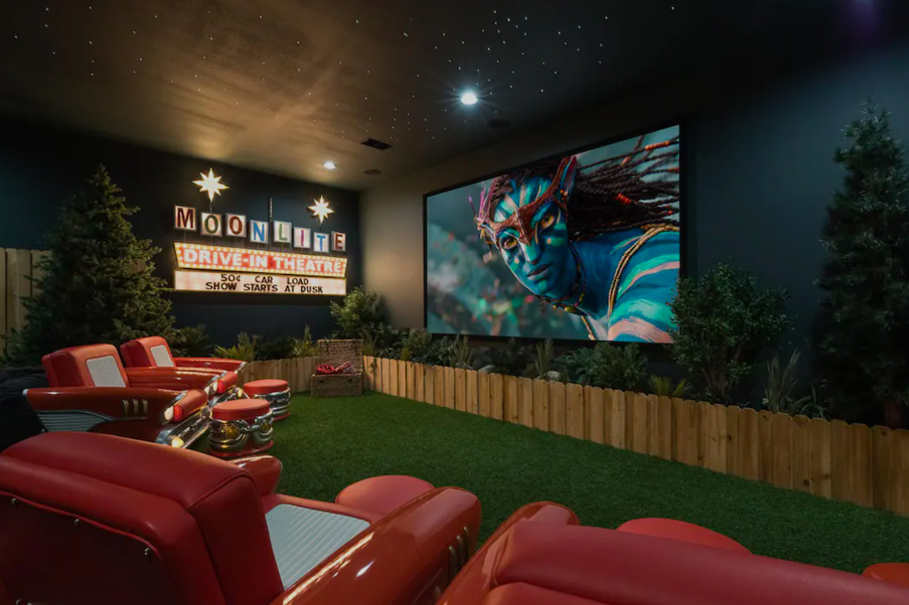 Luxury home with home theater and pool
Kissimmee, $3,079 per night
This massive themed home comes with a Dino Arcade (housing a “life-size” T-Rex and a tube slide), a bar, shuffleboard, pool and a drive-in movie home theater. 
Photo via Airbnb