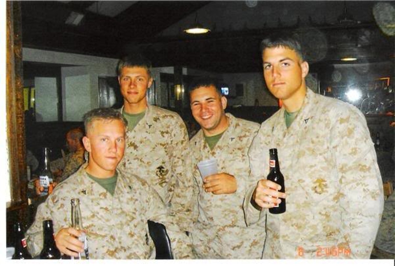 Left to Right- Lcpl. Ross Smith (KIA), Lcpl. Joe Sawyer, Lcpl. Richard Ryba and Lcpl. Fred Lambert. The four Marines enjoy beers in the Bangor Airport during a layover in their flight from Iraq in Spring 2005. Smith would be killed in 2006 during his third tour to the region.