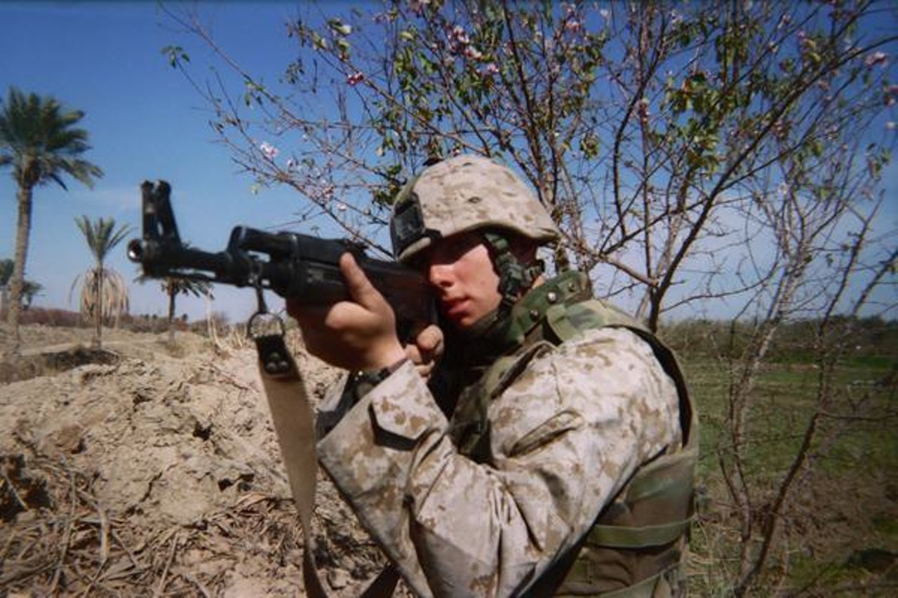 Fred sports an Iraqi soldier's AK-47 (traded with his M-16 for the photo) in a defensive position outside the city of Saqlawiyah, just north of Fallujah, Iraq.