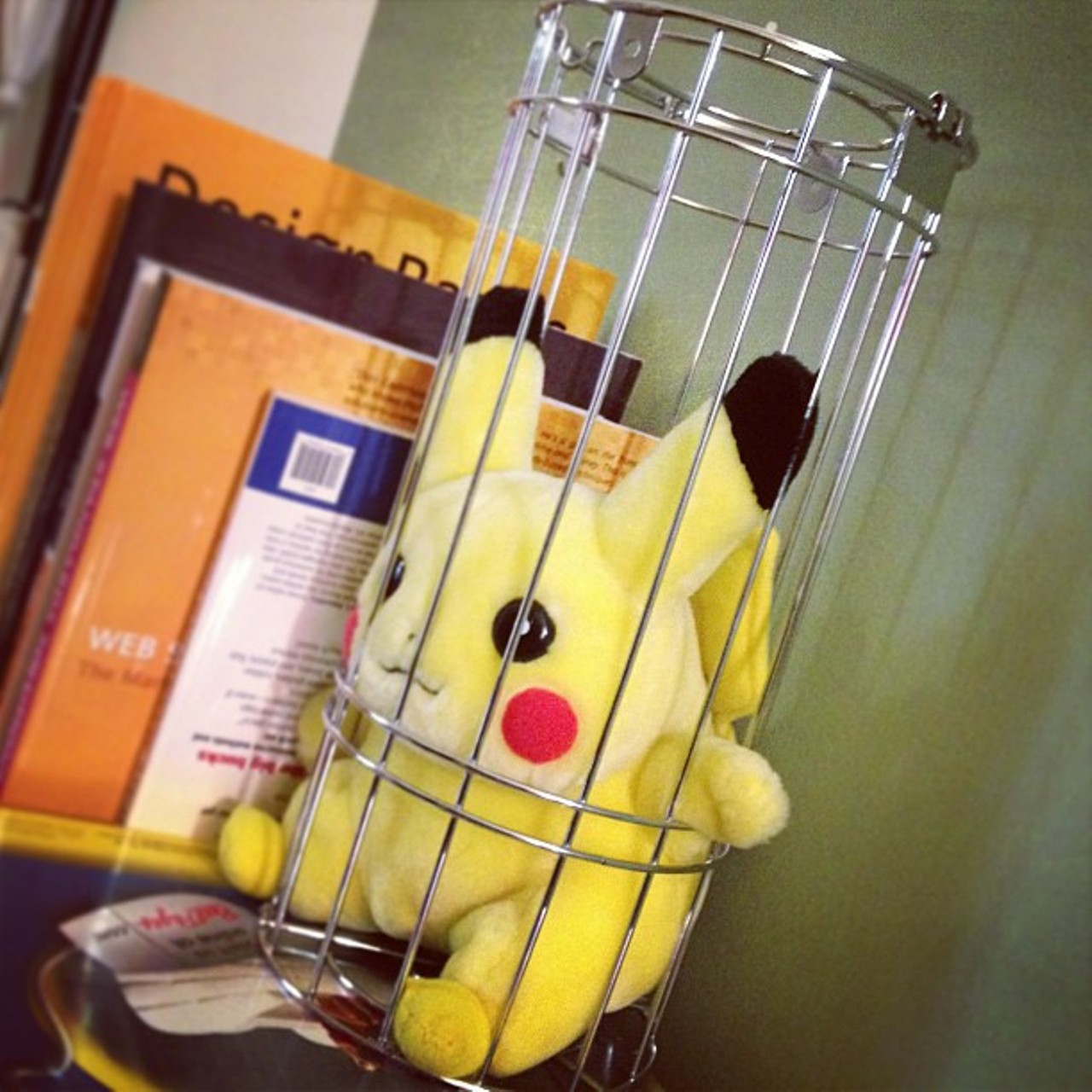 @grindigital #owwednesday Yes, a cage-dancing Pikachu does indeed hold up the books in my office...What? Don't look at me like that.