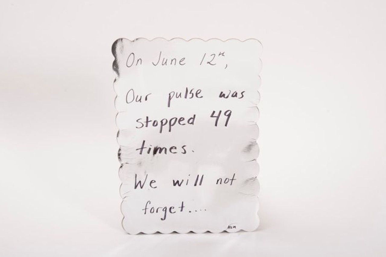 Poster 
Description: 
Silver poster with scalloped edges and a handwritten message in marker that says, &#147;On June 12th, Our pulse was stopped 49 times. We will not forget&#133;. / HLM.&#148;