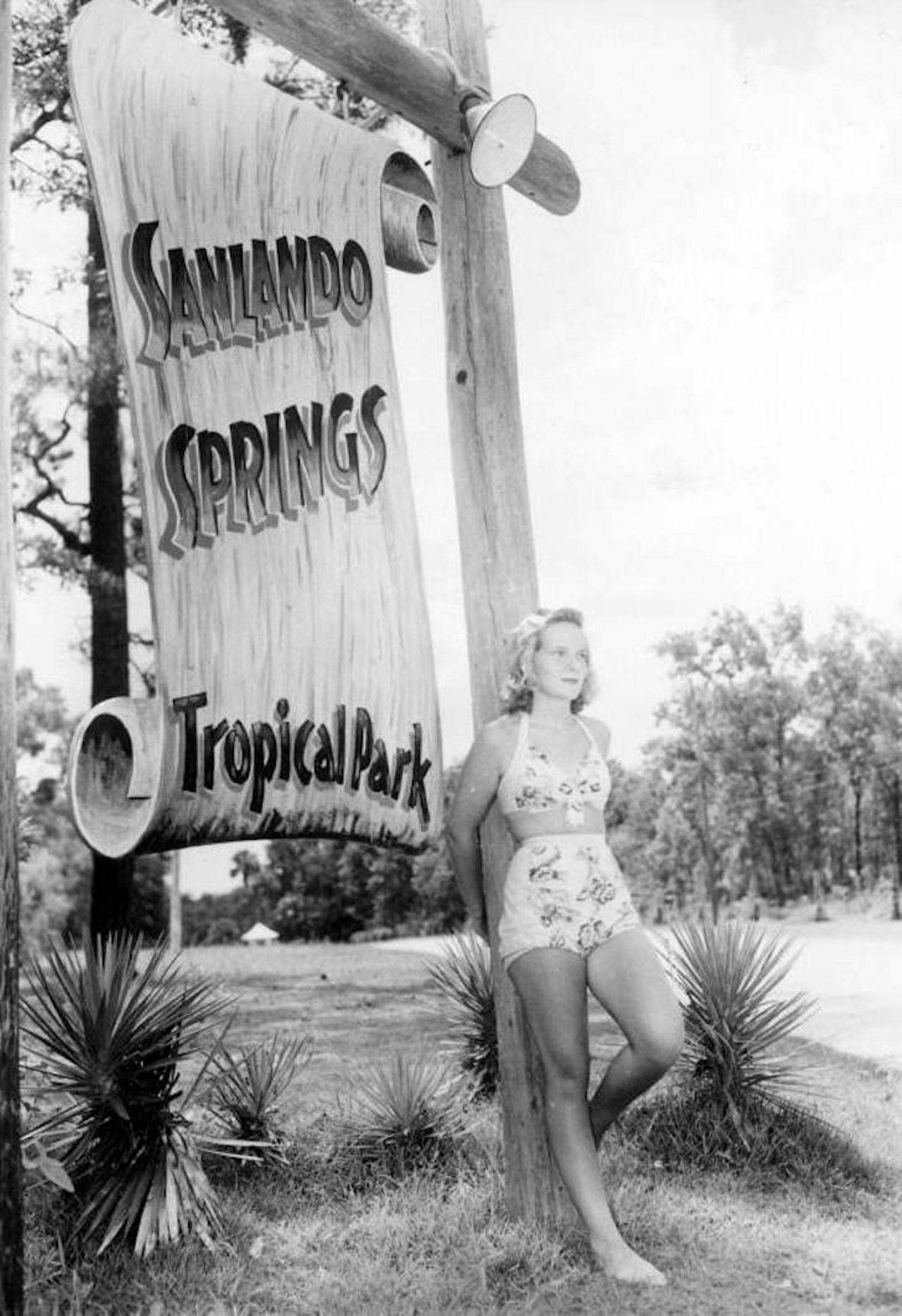 Jean Baker standing next to the Sanlando Springs' sign, 1946.