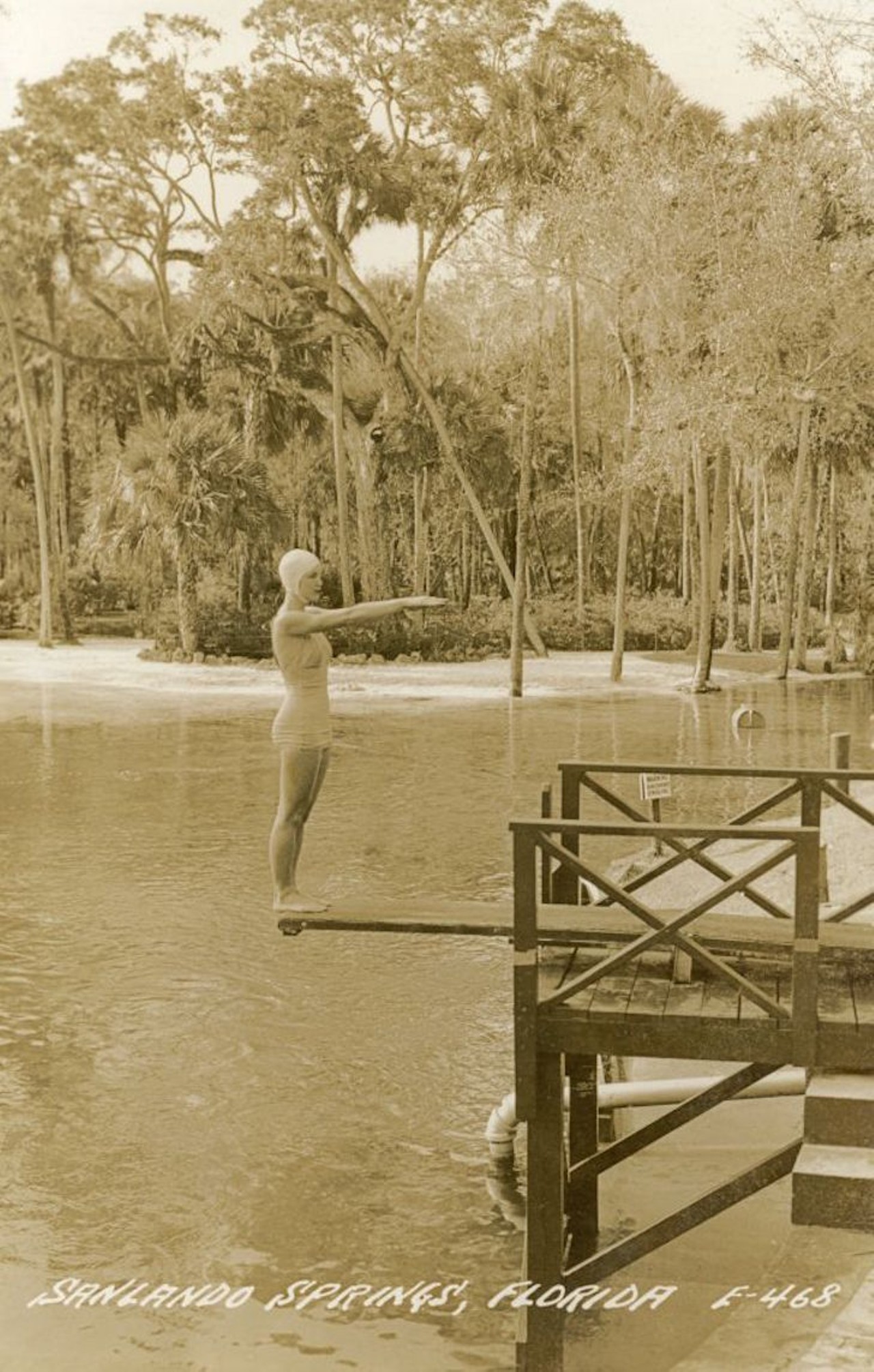 Woman using diving board at Sanlando Springs, likely after 1925.