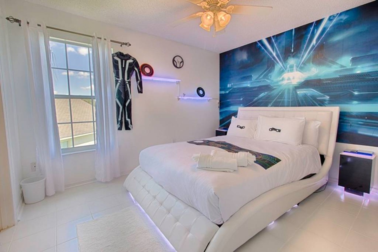 Themed villa only 4 miles to Disney
15 guests, 7 bedrooms, 10 beds, 4.5 baths
$295 per night
You can become a part of the cyberworld in this illuminated bedroom that sports those killer suits and Tron's video game inspired back wall.