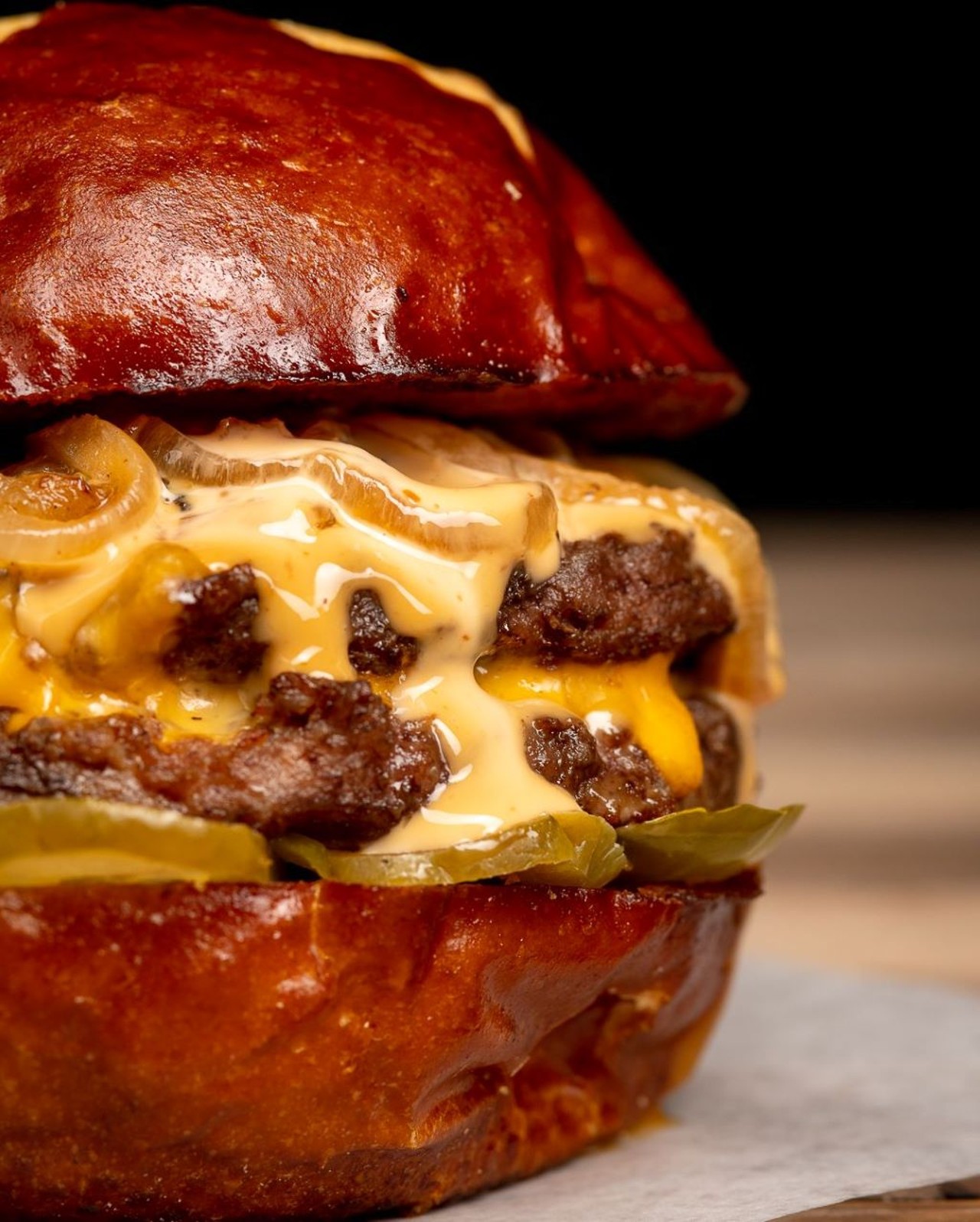 American Social 
407-454-9992, 7335 W. Sand Lake Road #101
Stop by during their burger Mondays for a sweet deal on bourbon, whiskey and burgers. Their social smash burger is served on a pretzel bun and topped with caramelized onions, cheddar cheese, smash sauce and pickles. 
Photo via American Social/Facebook