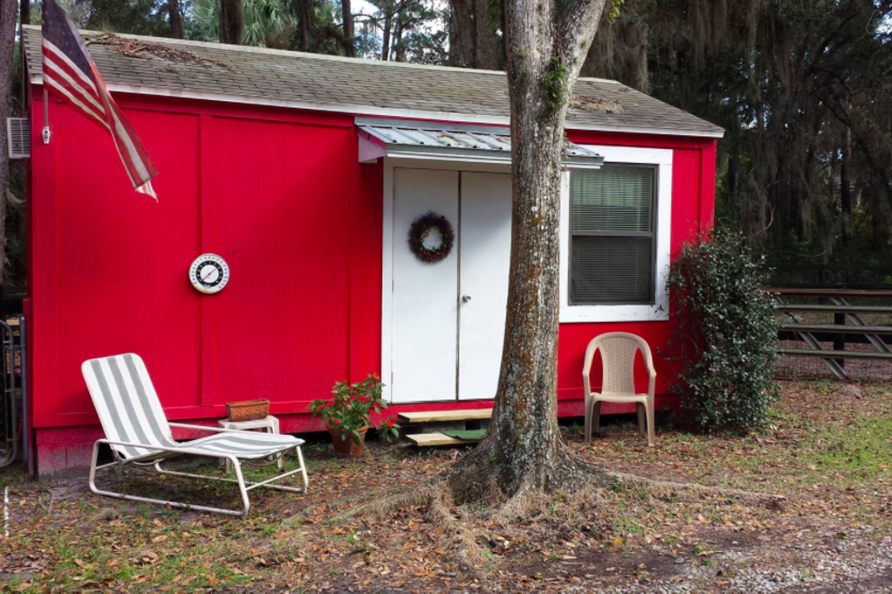 Kim's cute little red cabin in Sanford is tiny and rustic.