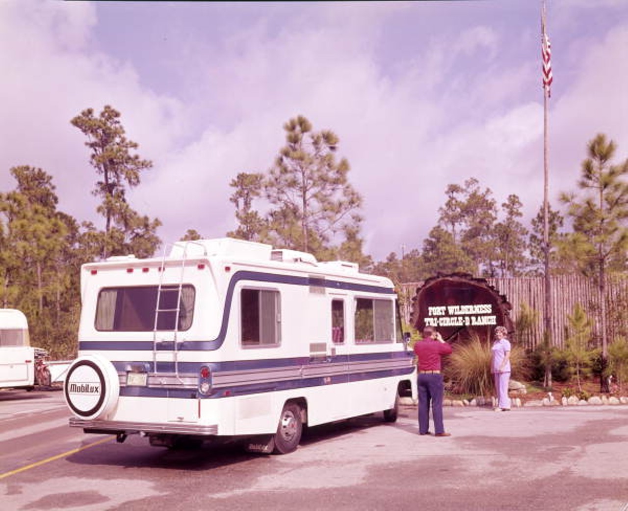 View of couple with their camper at the Walt Disney World Resort "Fort Wilderness" campground - Orlando, Florida, 1971