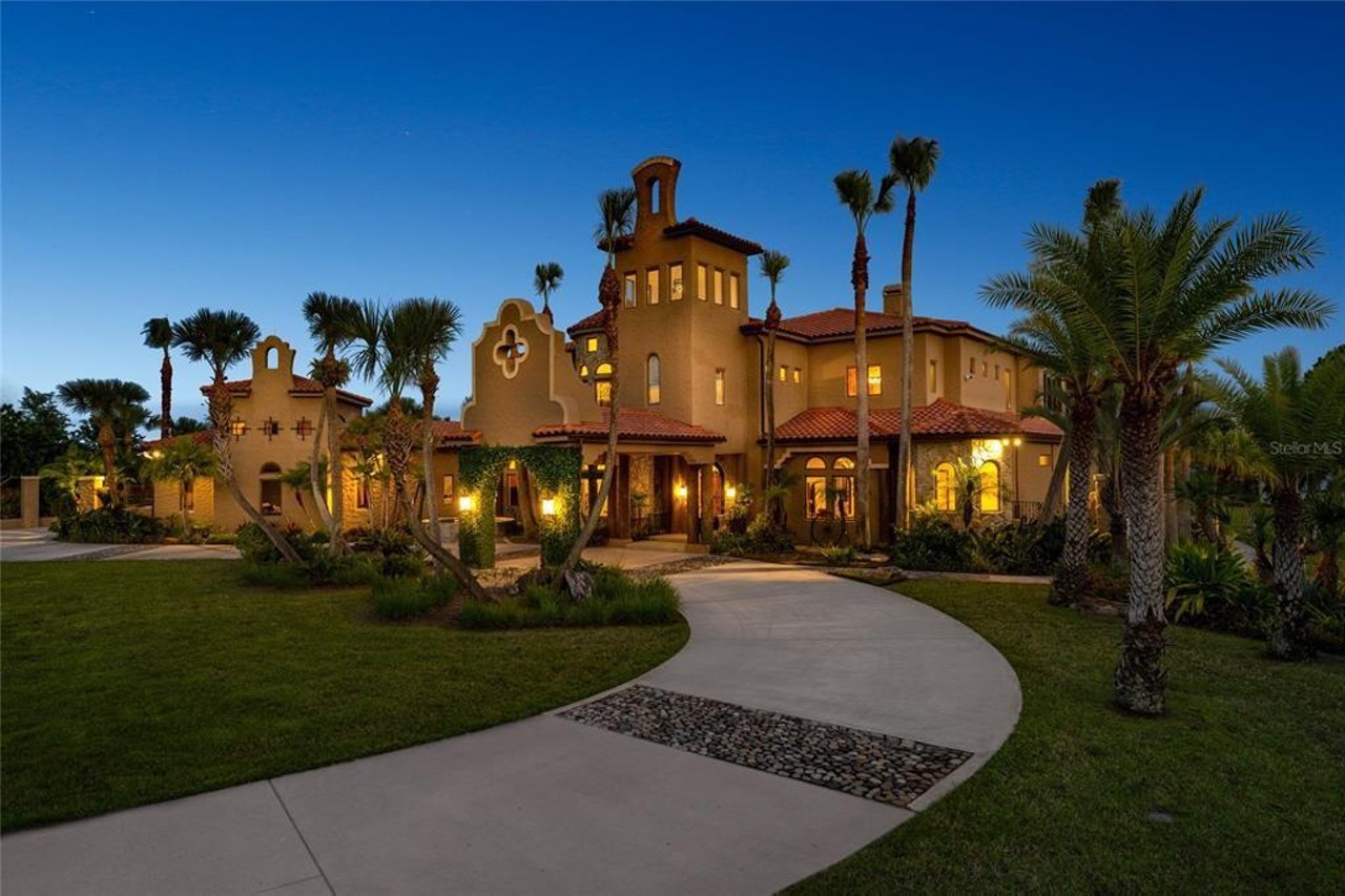This lakefront Mediterranean mansion in suburban Orlando once housed a zebra farm