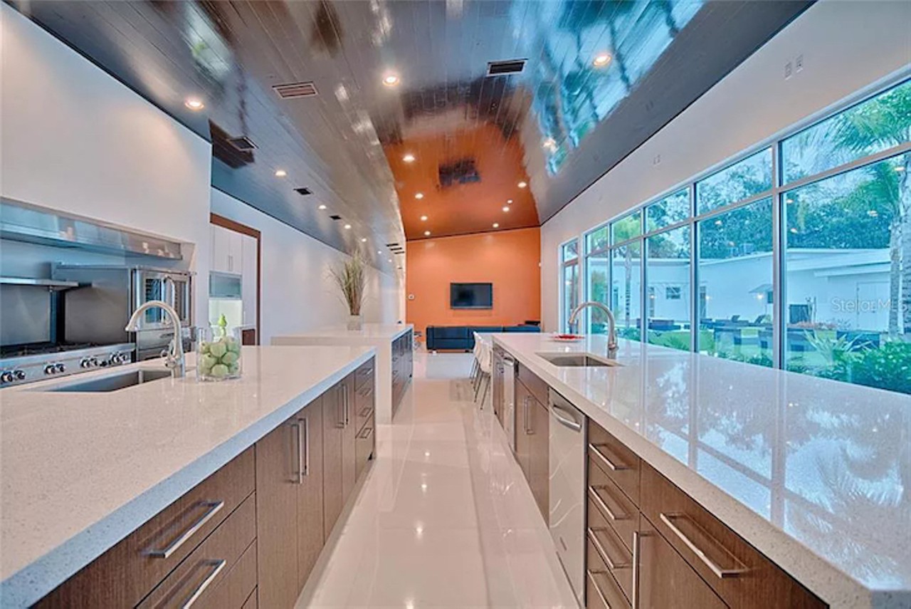 &#147;Commercial grade Chef's Kitchen with three stately islands and solid granite waterfall counters above the polished porcelain glass tile accentuate natural light. Dimmable lighting allows for opulent control of mood and ambiance.&#148;