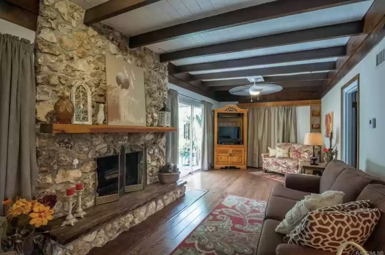 This riverfront Florida home comes with a guesthouse with a tree inside and a private island